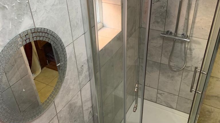 quadrant-shower-enclosure-with-patterned-tile-floor-16x9-1 Why Take Directions From a Bathroom Fitter